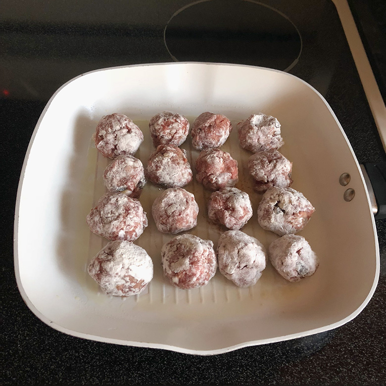 Meatballs on the pan before turning on the heat.